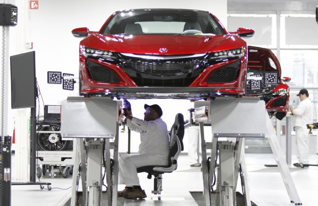 Carl Mason sits in the aligner chair during the wheel alignment process. Because the NSX is so low, associates would have had to be in a crouched position for long periods of time to perform its alignment. This special chair hangs on rails and allows an associate comfort while doing this 45-minute process.